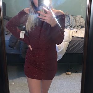 Red off the shoulder long sleeve sparkly dress.